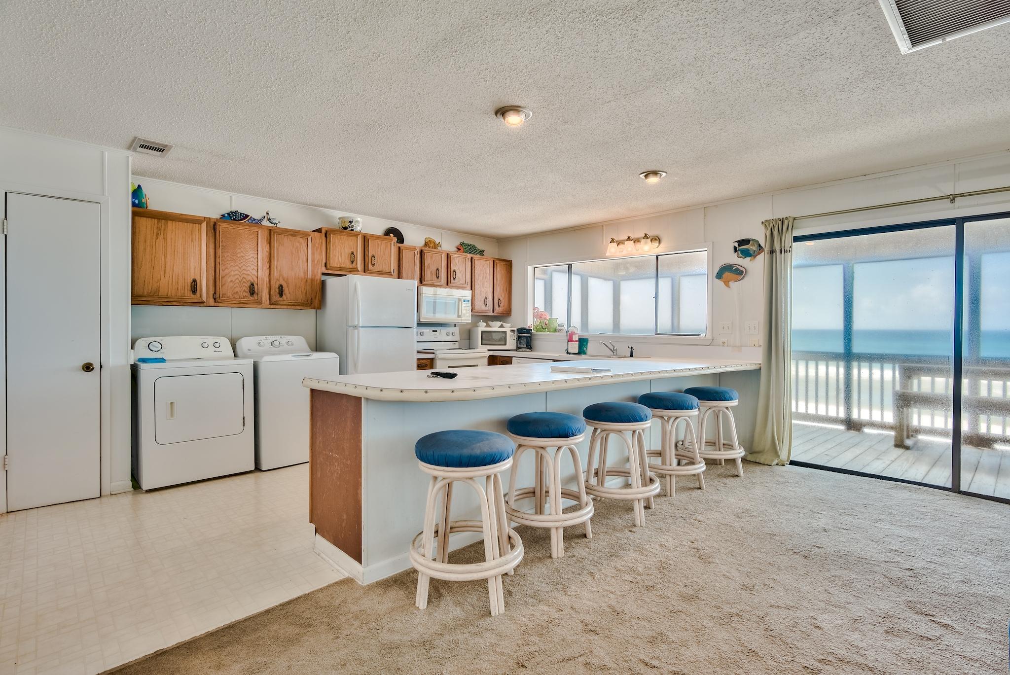 5357 West County Highway 30A Santa Rosa Beach, FL 32459 - Photo 12 of 22 a kitchen with appliances a sink and cabinets