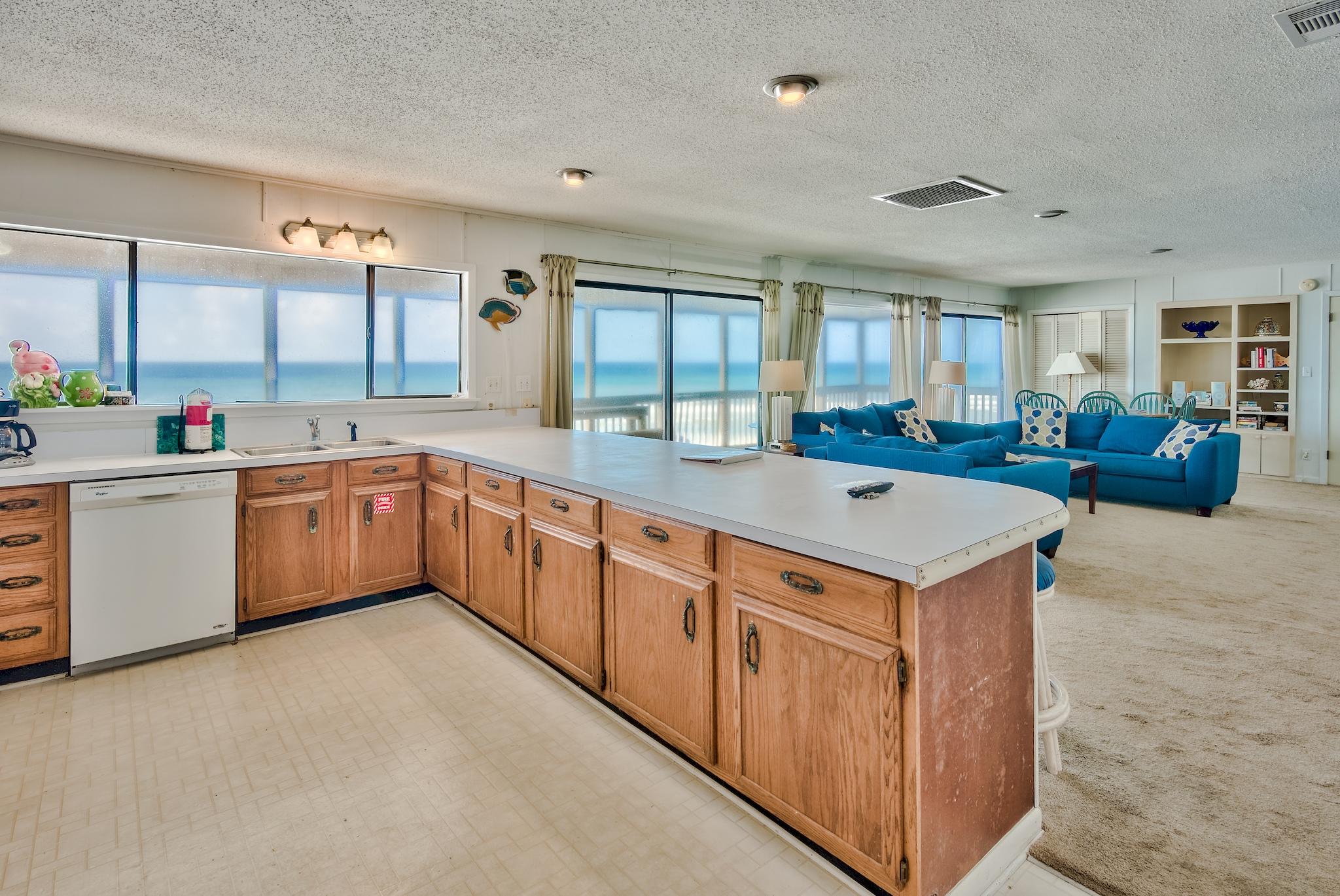 5357 West County Highway 30A Santa Rosa Beach, FL 32459 - Photo 13 of 22 a kitchen with stainless steel appliances a sink stove and cabinets