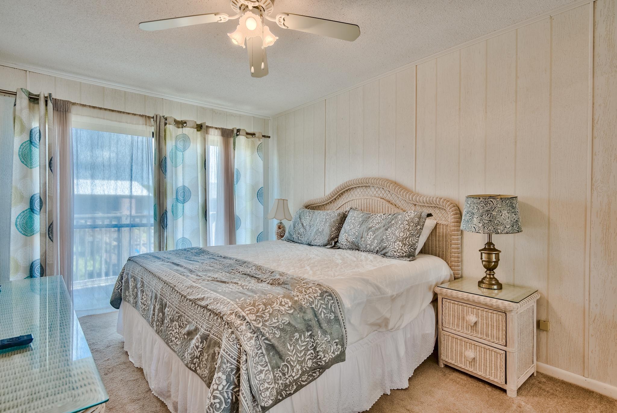 5357 West County Highway 30A Santa Rosa Beach, FL 32459 - Photo 14 of 22 a bedroom with a bed and a chandelier