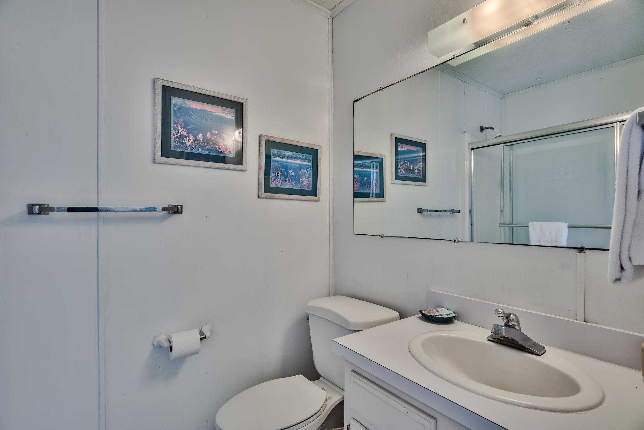 5357 West County Highway 30A Santa Rosa Beach, FL 32459 - Photo 16 of 22 a bathroom with a toilet sink and mirror