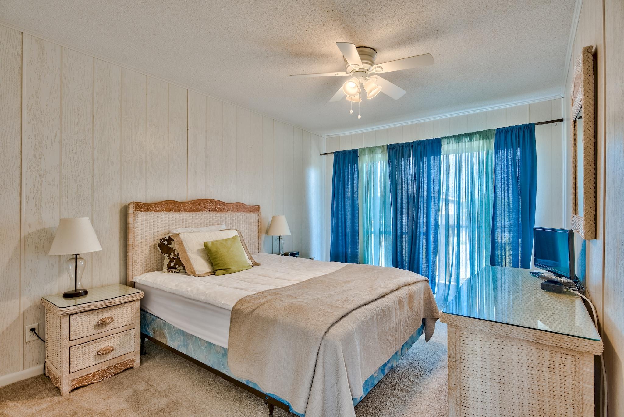 5357 West County Highway 30A Santa Rosa Beach, FL 32459 - Photo 17 of 22 a bedroom with a large bed and a chandelier