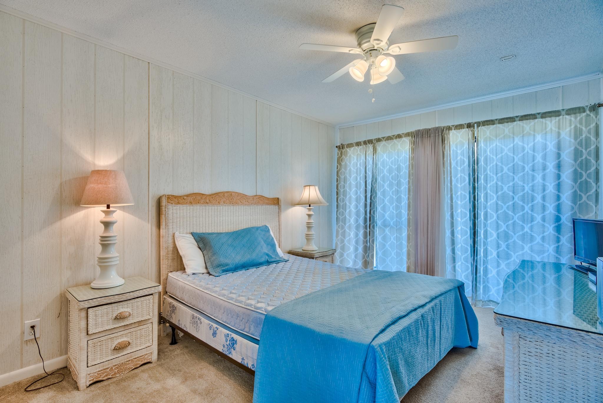 5357 West County Highway 30A Santa Rosa Beach, FL 32459 - Photo 20 of 22 a bedroom with a bed and a chandelier