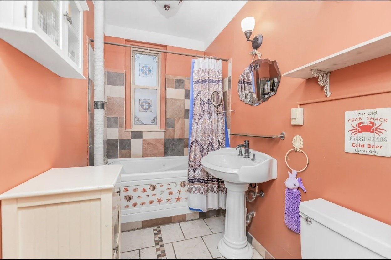 15 Fort Washington Avenue, Unit 3A Manhattan, NY 10032 - Photo 6 of 15 a bathroom with a sink a mirror and a shower