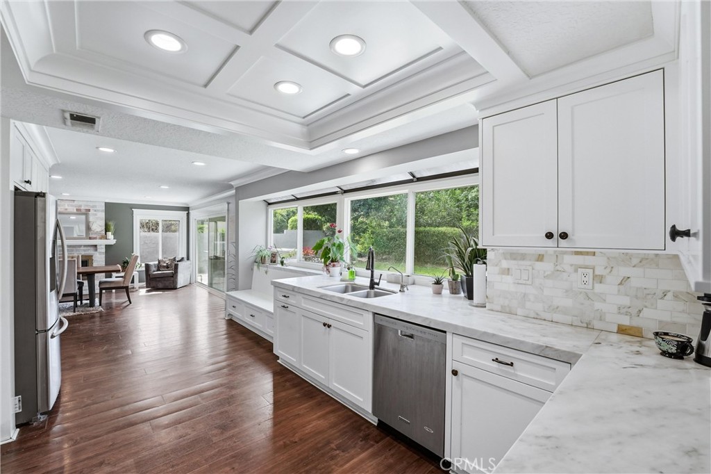 282 North Willow Springs Road Orange, CA 92869 - Photo 11 of 43 a large white kitchen with lots of counter space and painting on the wall
