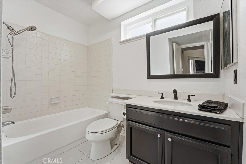 282 North Willow Springs Road Orange, CA 92869 - Photo 21 of 43 a bathroom with a toilet a sink a mirror and a bathtub