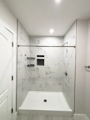 a bathroom with a shower and a sink