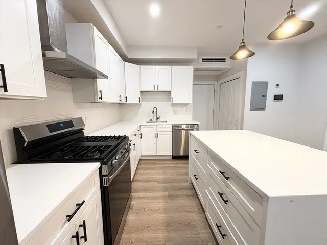 a kitchen with a stove and a sink