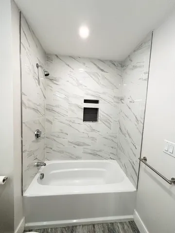 a bathroom with a bathtub and a shower