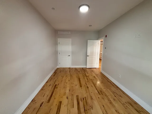 a view of hallway with wooden floor