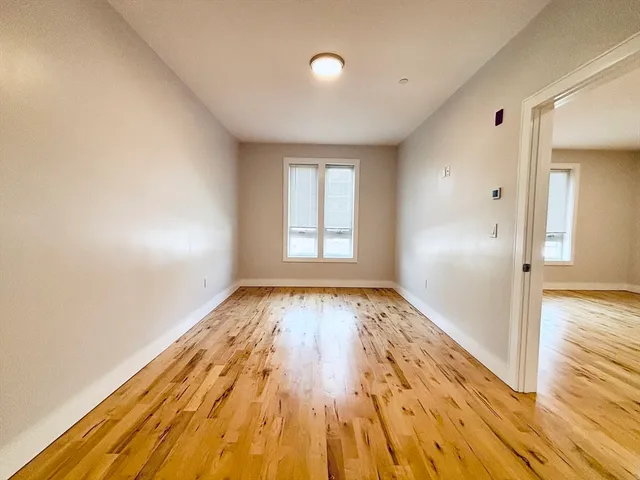 a view of an empty room and wooden floor