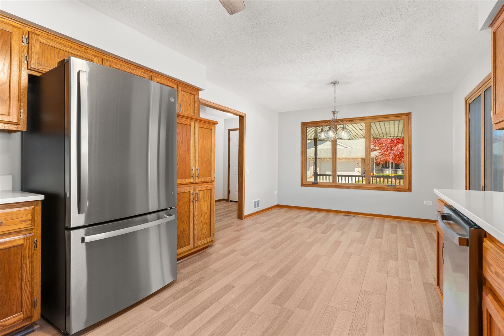 822 Eagle Creek Road Elwood, IL 60421 - Photo 11 of 41 a kitchen with stainless steel appliances a refrigerator and wooden floor