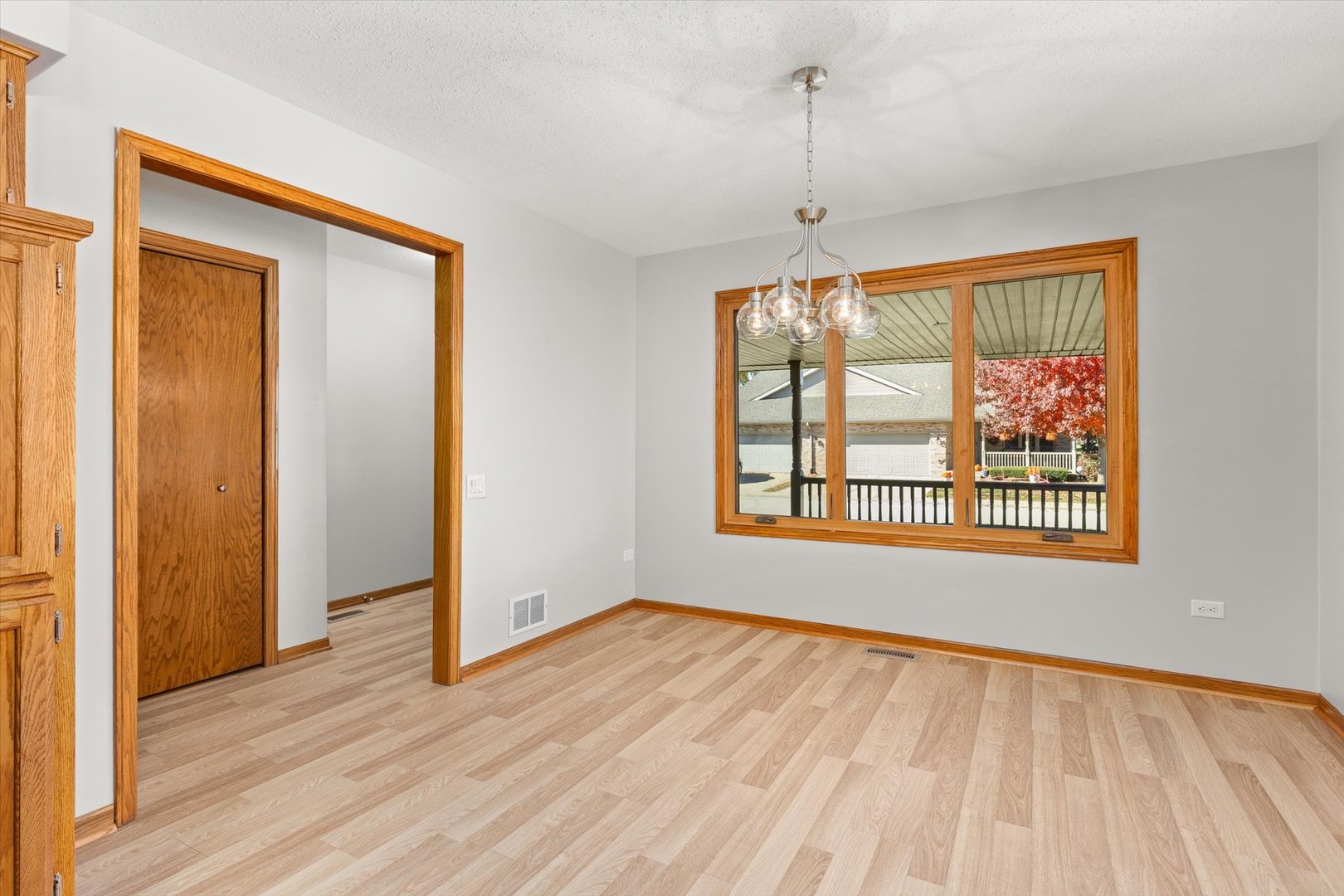 822 Eagle Creek Road Elwood, IL 60421 - Photo 12 of 41 a view of an empty room with wooden floor and a window