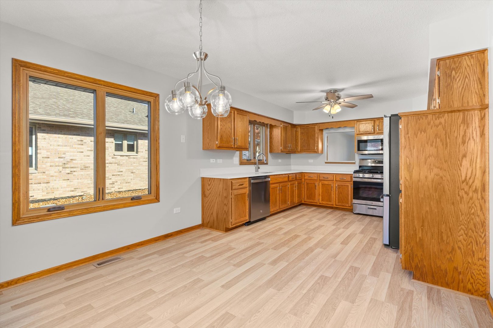 822 Eagle Creek Road Elwood, IL 60421 - Photo 7 of 41 a large kitchen with stainless steel appliances granite countertop a stove and a refrigerator