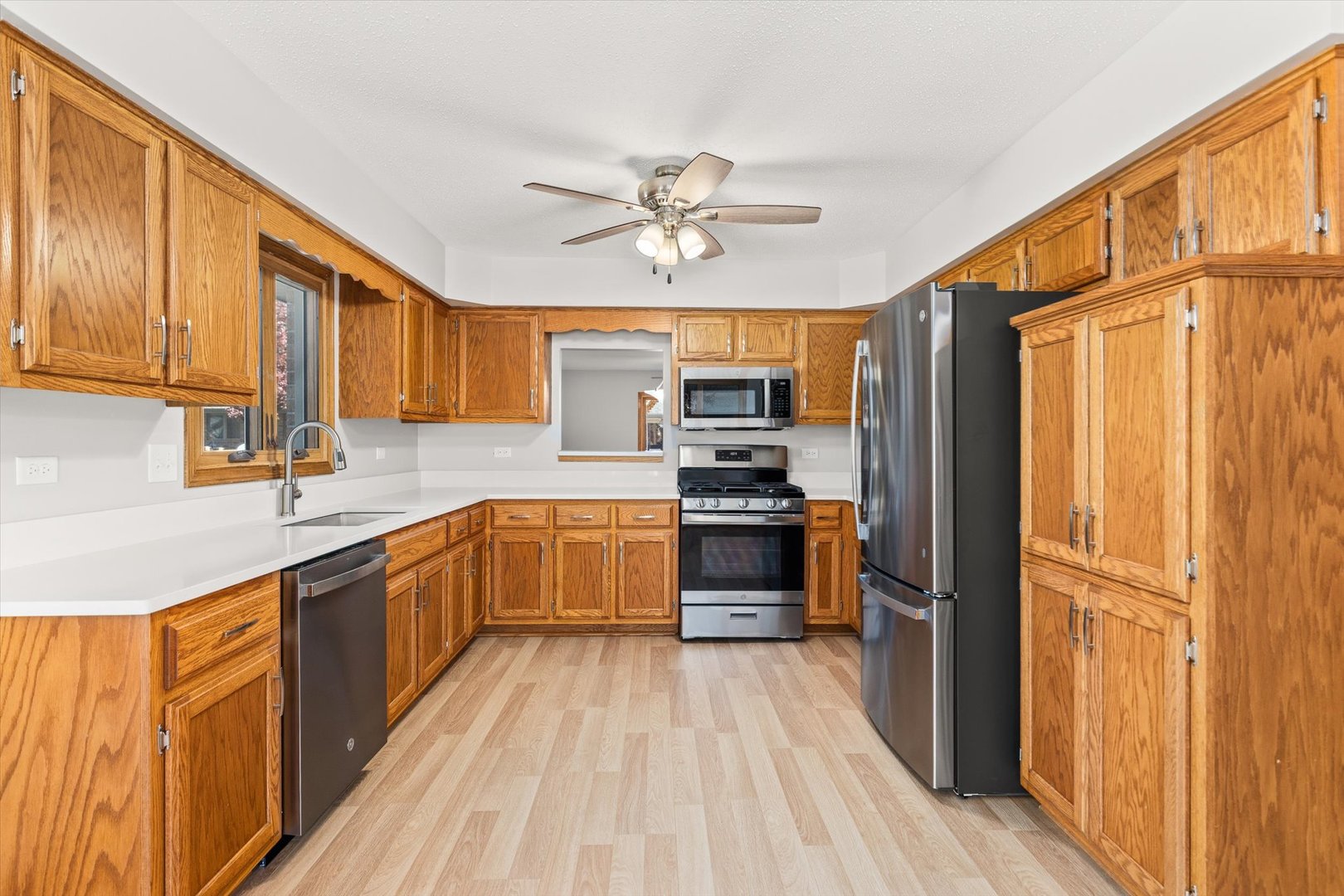 822 Eagle Creek Road Elwood, IL 60421 - Photo 9 of 41 a kitchen with stainless steel appliances a refrigerator sink and microwave
