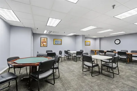 a hallway with wooden floor windows and stairs
