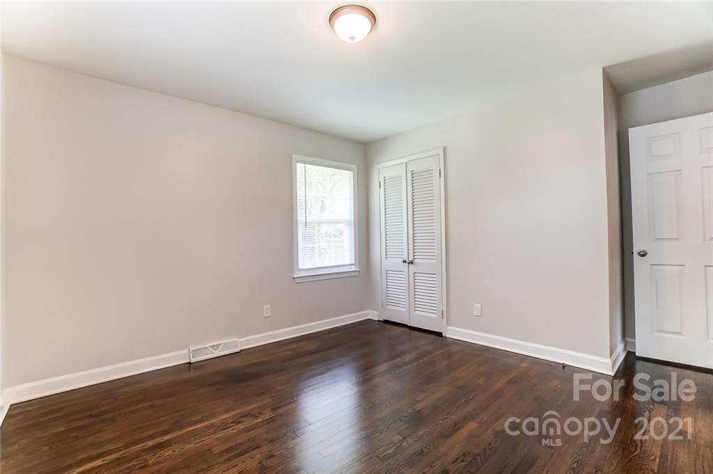 4033 Fieldcrest Road Charlotte, NC 28217 - Photo 11 of 17 an empty room with wooden floor and windows