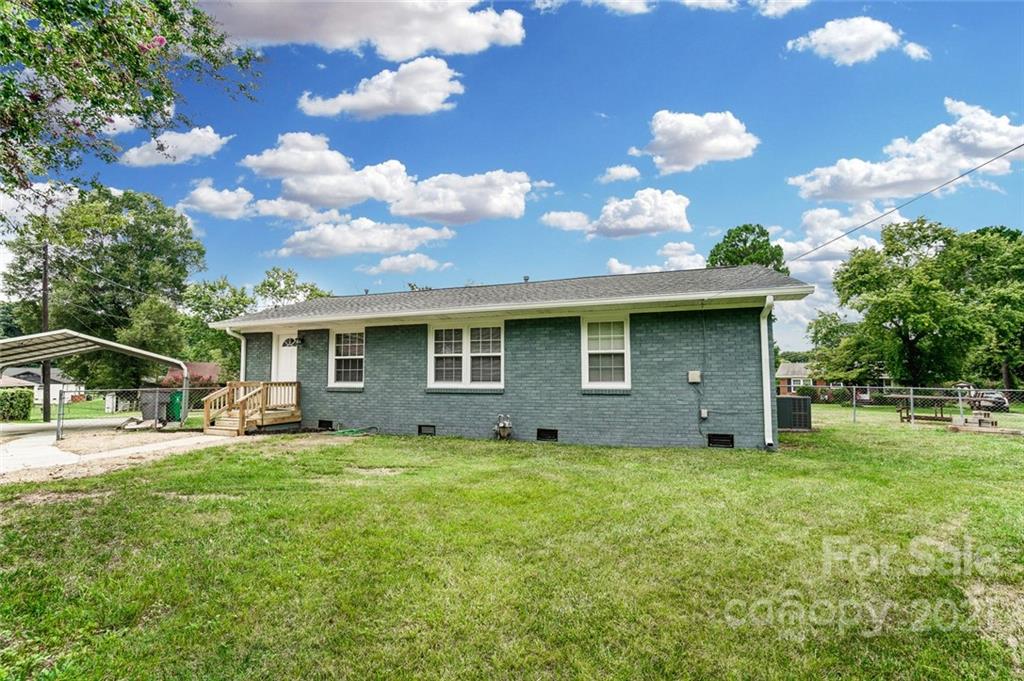 4033 Fieldcrest Road Charlotte, NC 28217 - Photo 12 of 17 a view of a house with yard