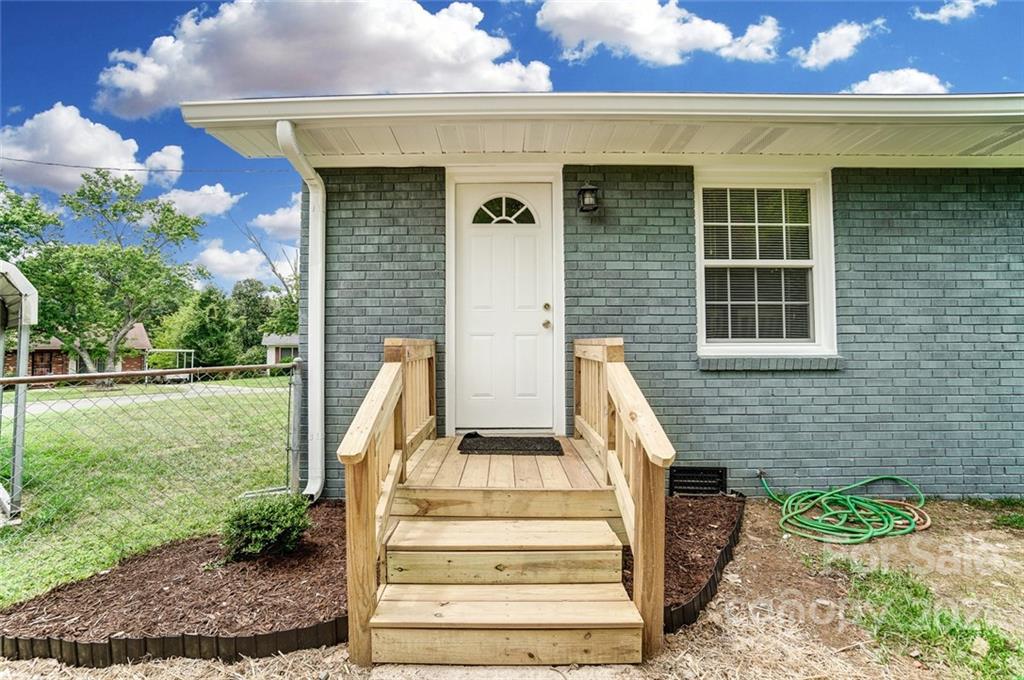 4033 Fieldcrest Road Charlotte, NC 28217 - Photo 13 of 17 a front view of a house with a garden