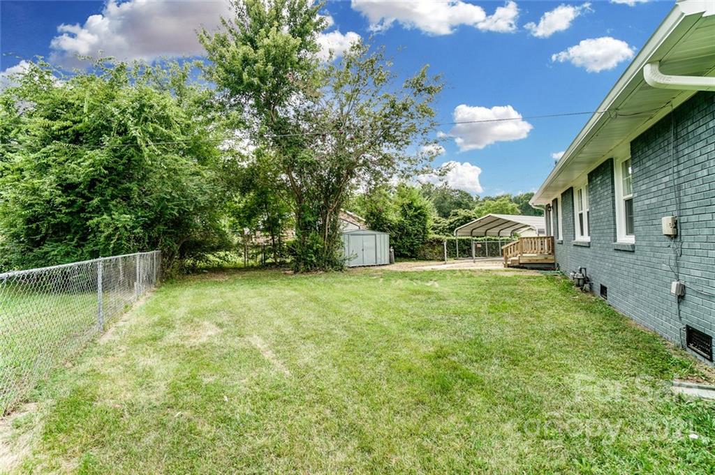 4033 Fieldcrest Road Charlotte, NC 28217 - Photo 15 of 17 a view of a backyard with a garden and plants