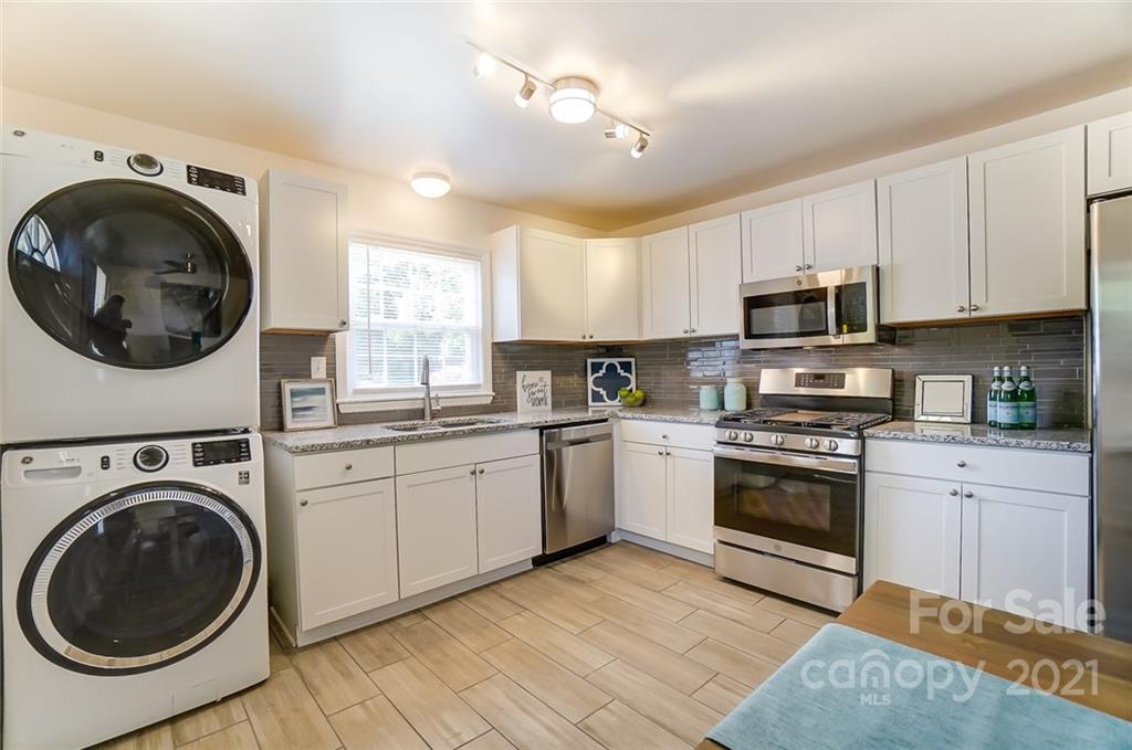 4033 Fieldcrest Road Charlotte, NC 28217 - Photo 6 of 17 a kitchen with granite countertop a sink a stove top oven and cabinets