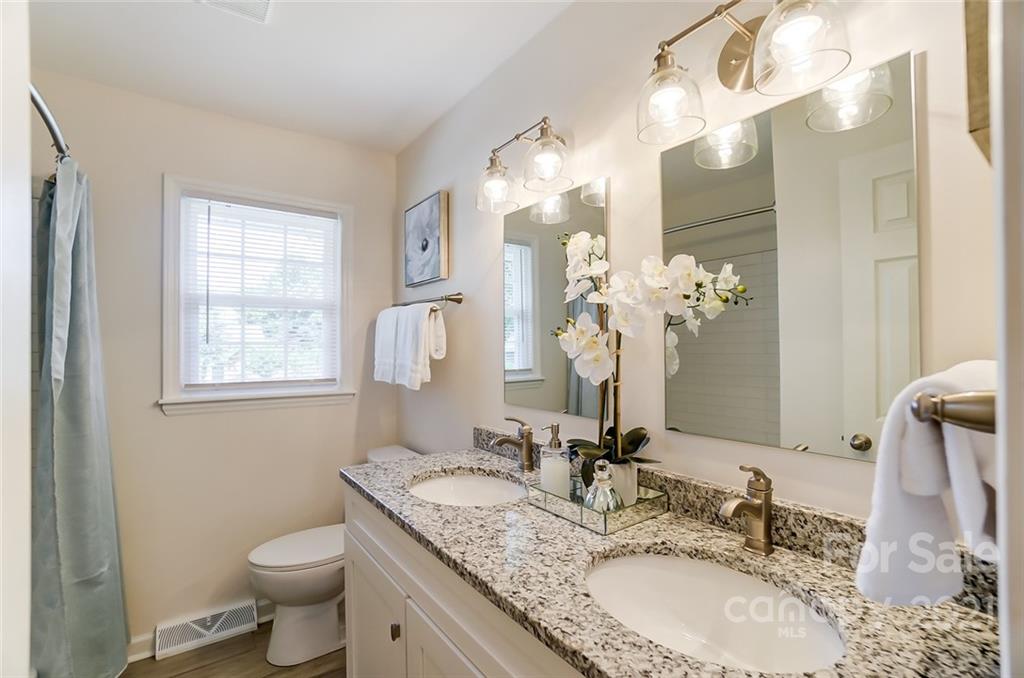 4033 Fieldcrest Road Charlotte, NC 28217 - Photo 8 of 17 a bathroom with a granite countertop double vanity sink mirror and toilet