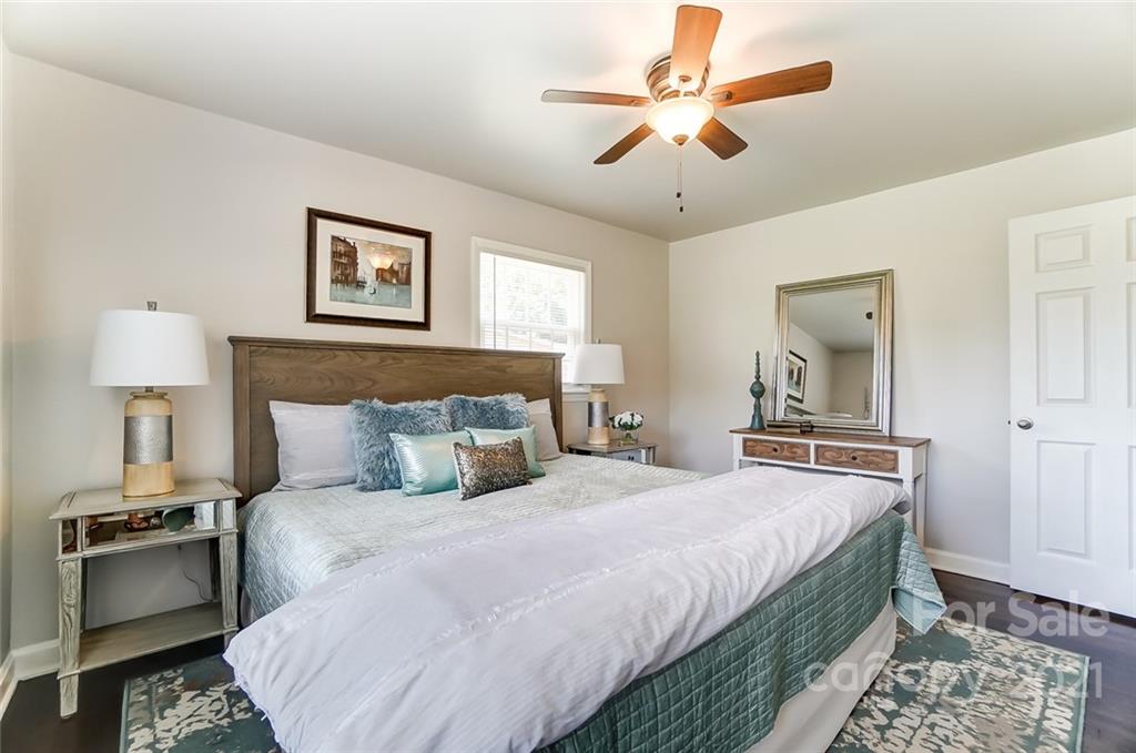 4033 Fieldcrest Road Charlotte, NC 28217 - Photo 10 of 17 a bedroom with bed and a chandelier
