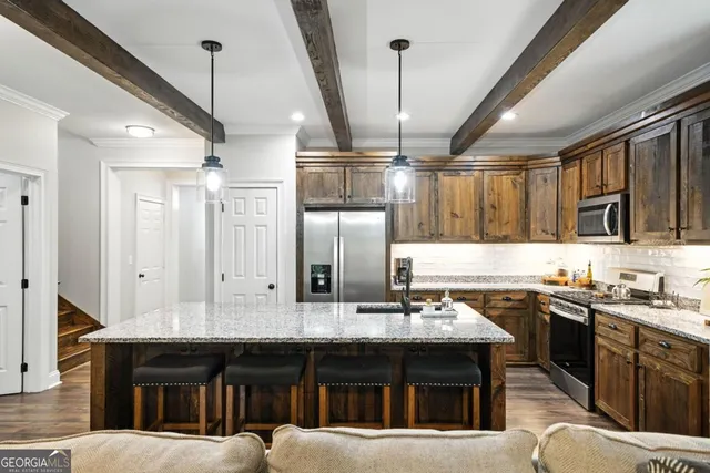 a kitchen with a sink stainless steel appliances and cabinets