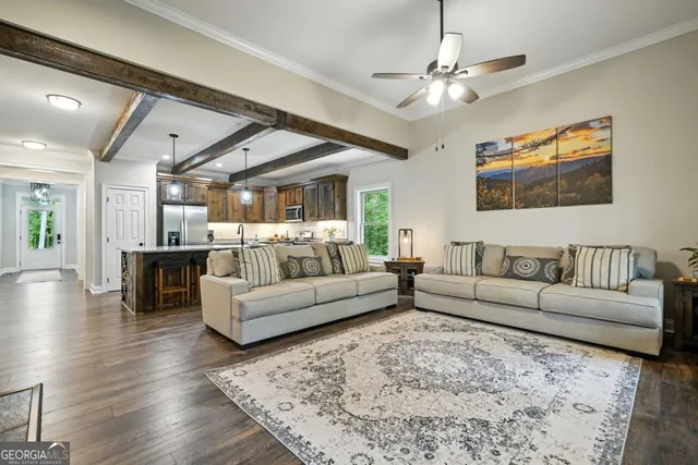 a living room with furniture and a chandelier