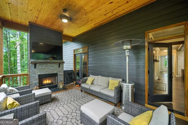 a living room with furniture flat screen tv and a fireplace