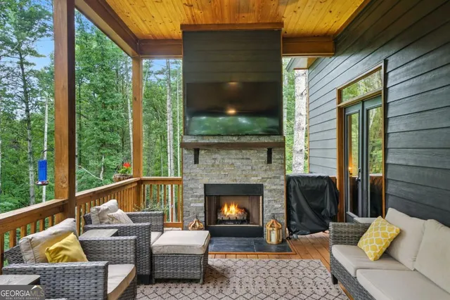 a balcony with furniture and a fireplace