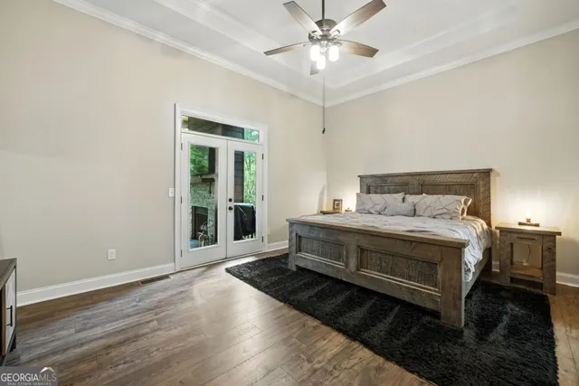 a spacious bedroom with a bed and a chandelier