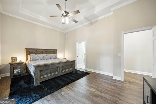 a view of bedroom with wooden floor