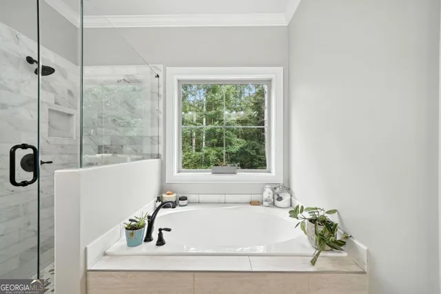 a bathroom with a bathtub and shower