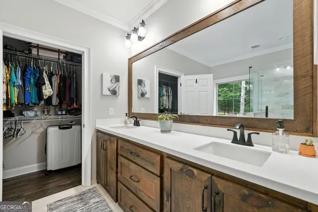 a bathroom with double vanity sinks a mirror and a shower