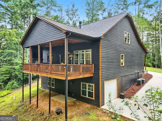 a view of a house with a porch and a floor to ceiling window