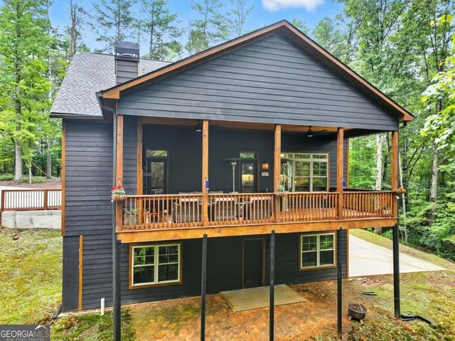 a view of house with backyard