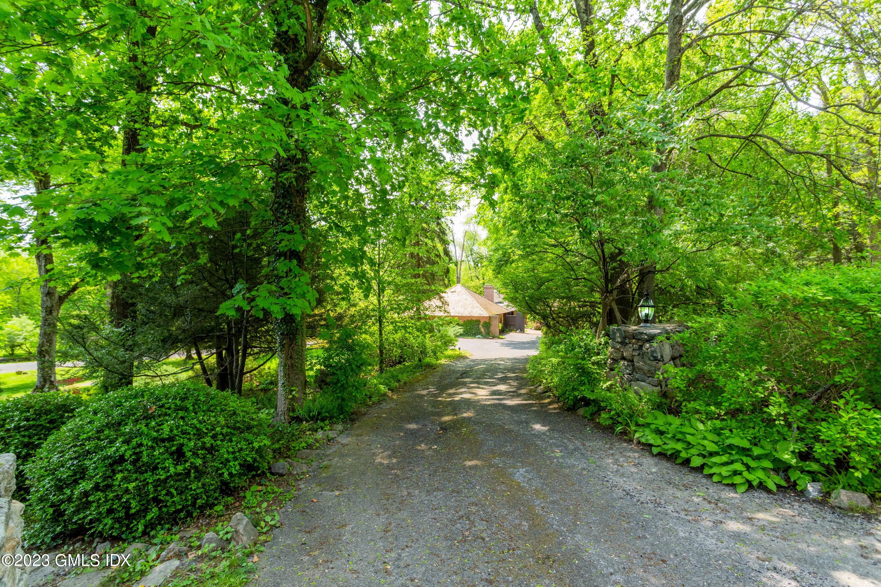 140 Round Hill Road Greenwich, CT 06831 - Photo 1 of 49 a view of a pathway with a tree