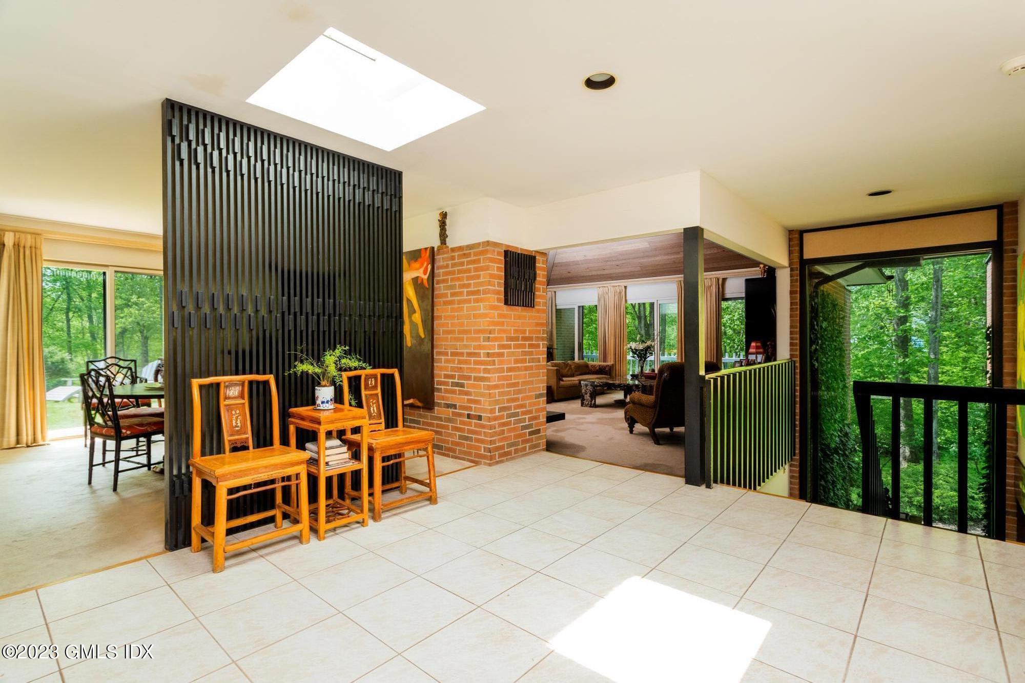 140 Round Hill Road Greenwich, CT 06831 - Photo 11 of 49 a bedroom with furniture and large windows