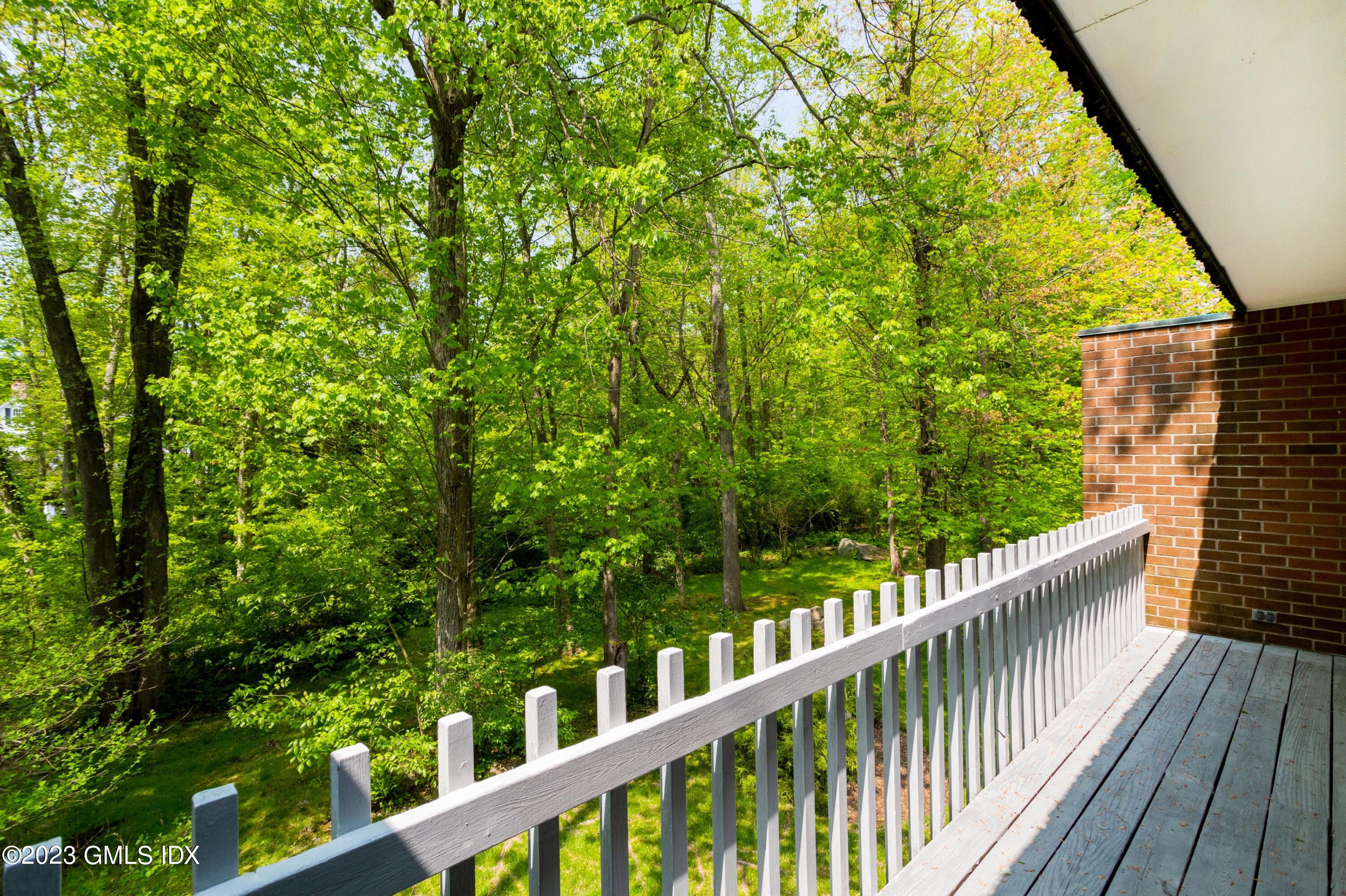 140 Round Hill Road Greenwich, CT 06831 - Photo 15 of 49 a view of a wooden balcony and trees