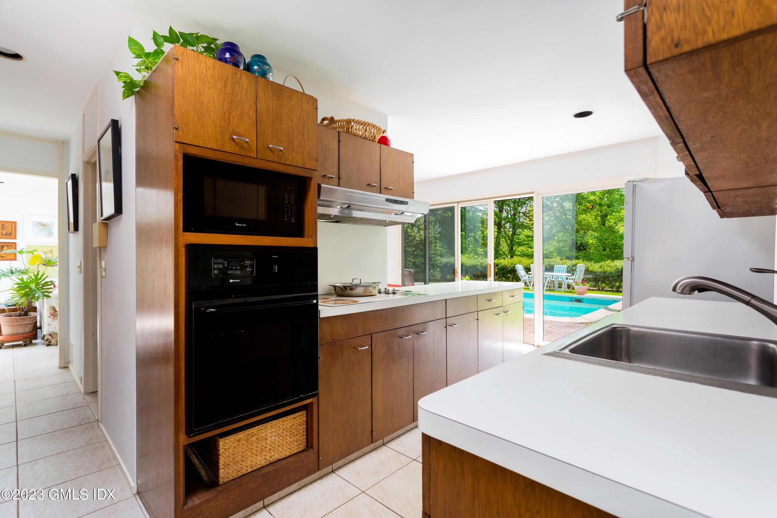 140 Round Hill Road Greenwich, CT 06831 - Photo 19 of 49 a kitchen that has a sink and a refrigerator