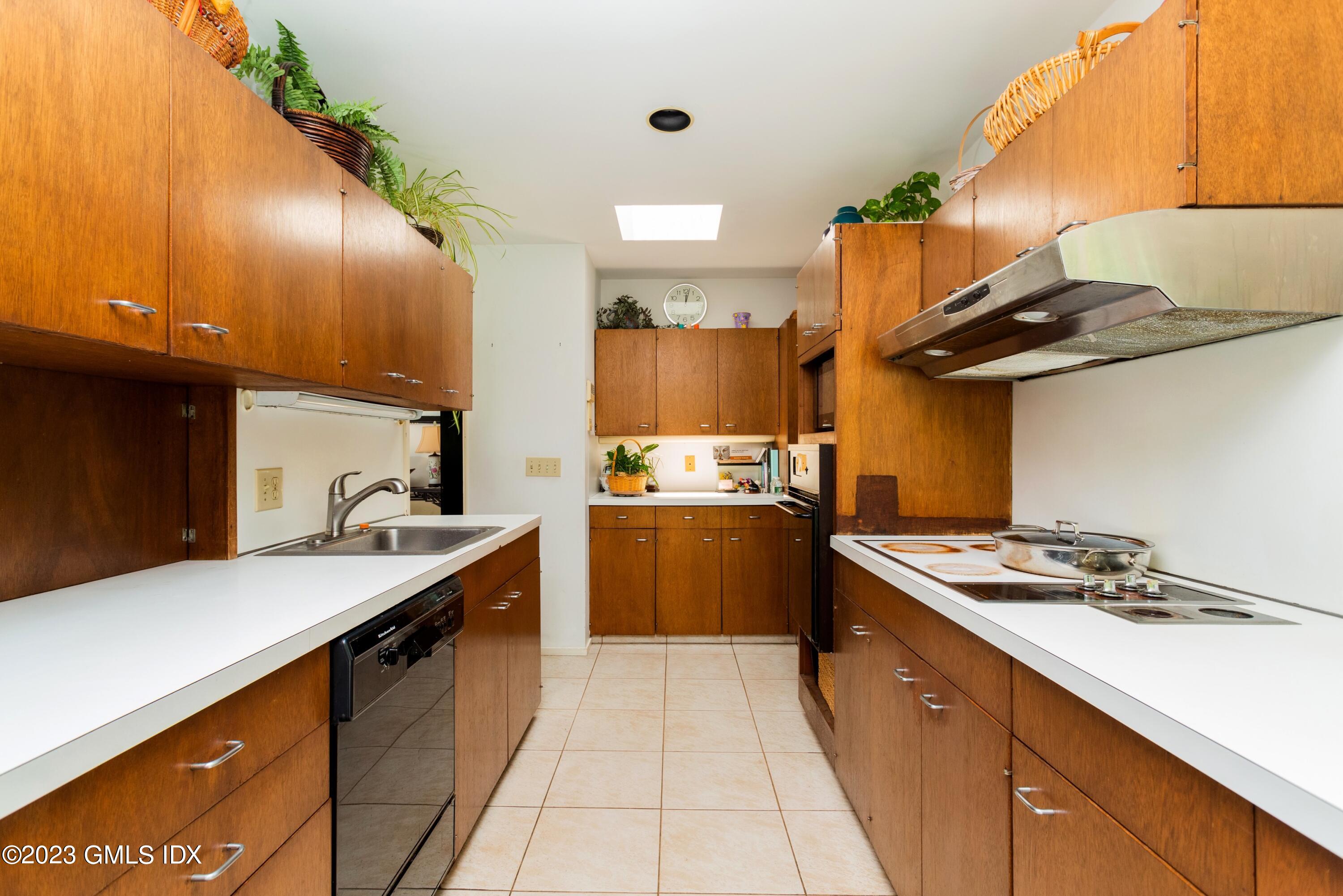 140 Round Hill Road Greenwich, CT 06831 - Photo 20 of 49 a kitchen with a sink a stove and chairs
