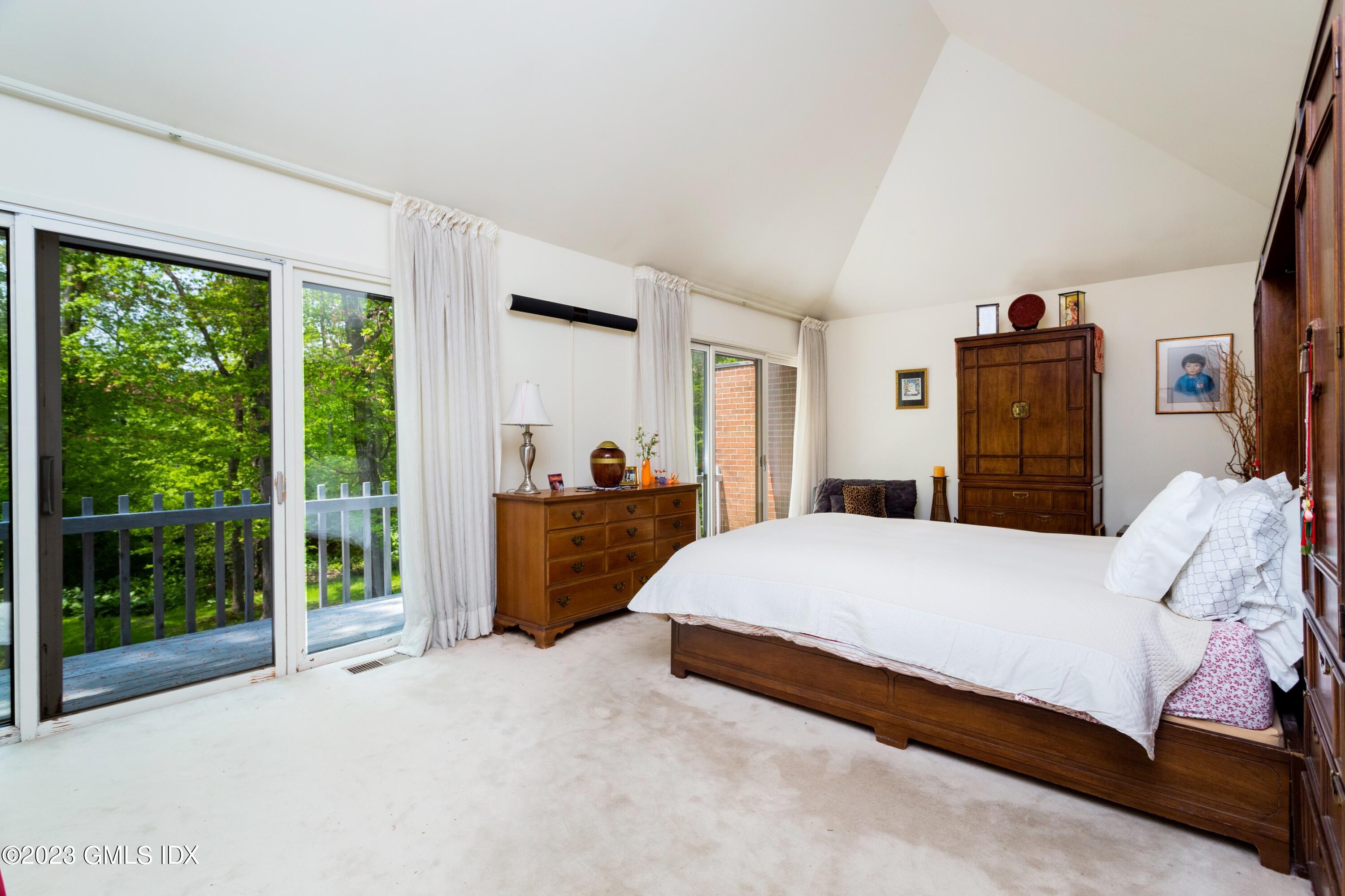 140 Round Hill Road Greenwich, CT 06831 - Photo 26 of 49 a bedroom with a large bed and a large window