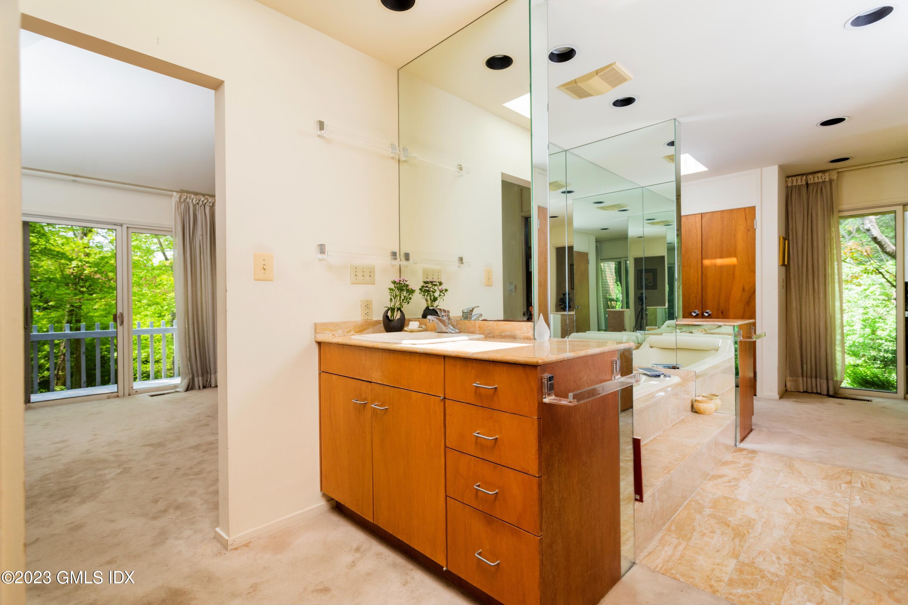 140 Round Hill Road Greenwich, CT 06831 - Photo 28 of 49 a spacious bathroom with a double vanity sink mirror and double