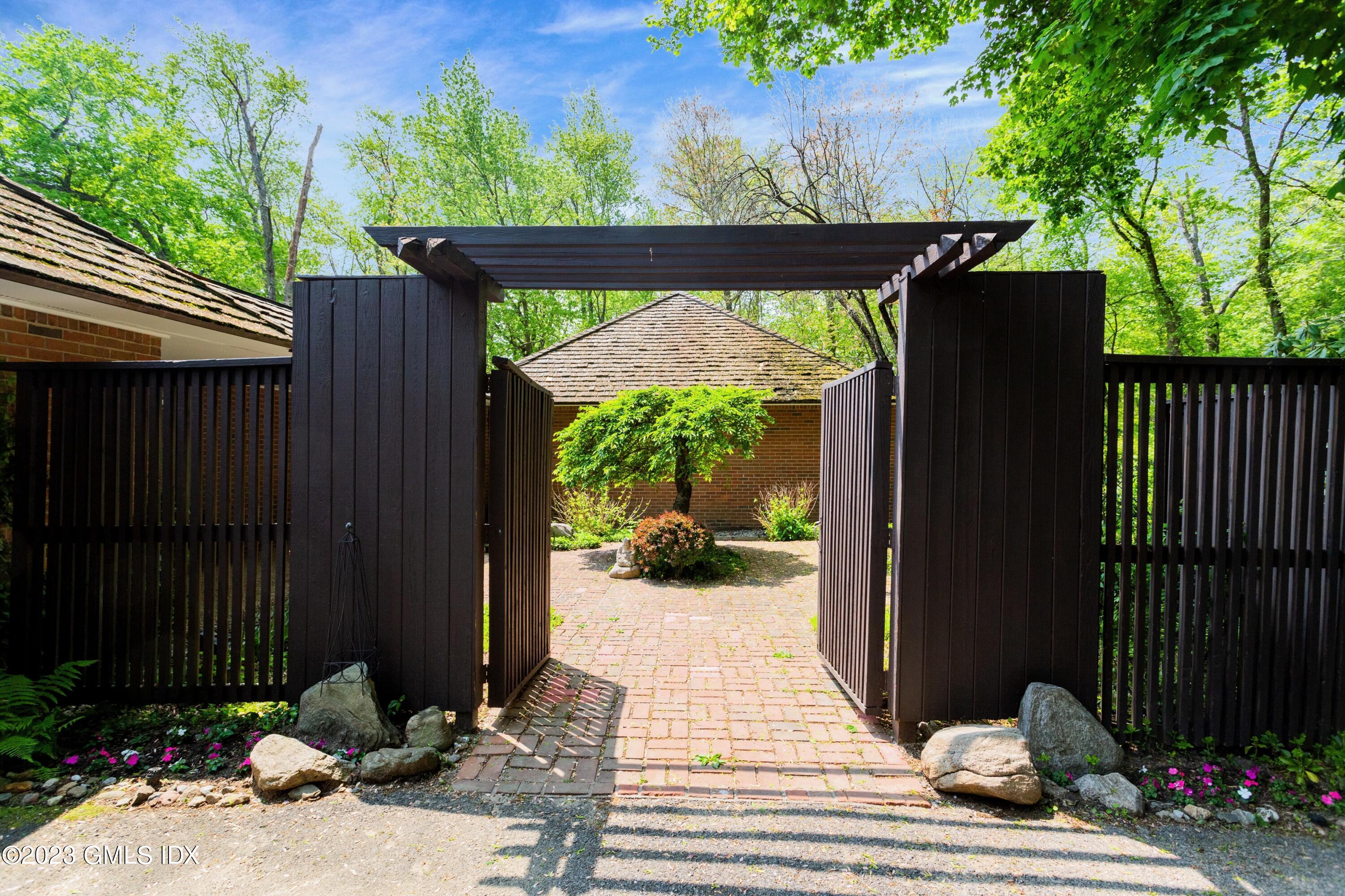 140 Round Hill Road Greenwich, CT 06831 - Photo 3 of 49 a view of a porch with a table and chairs