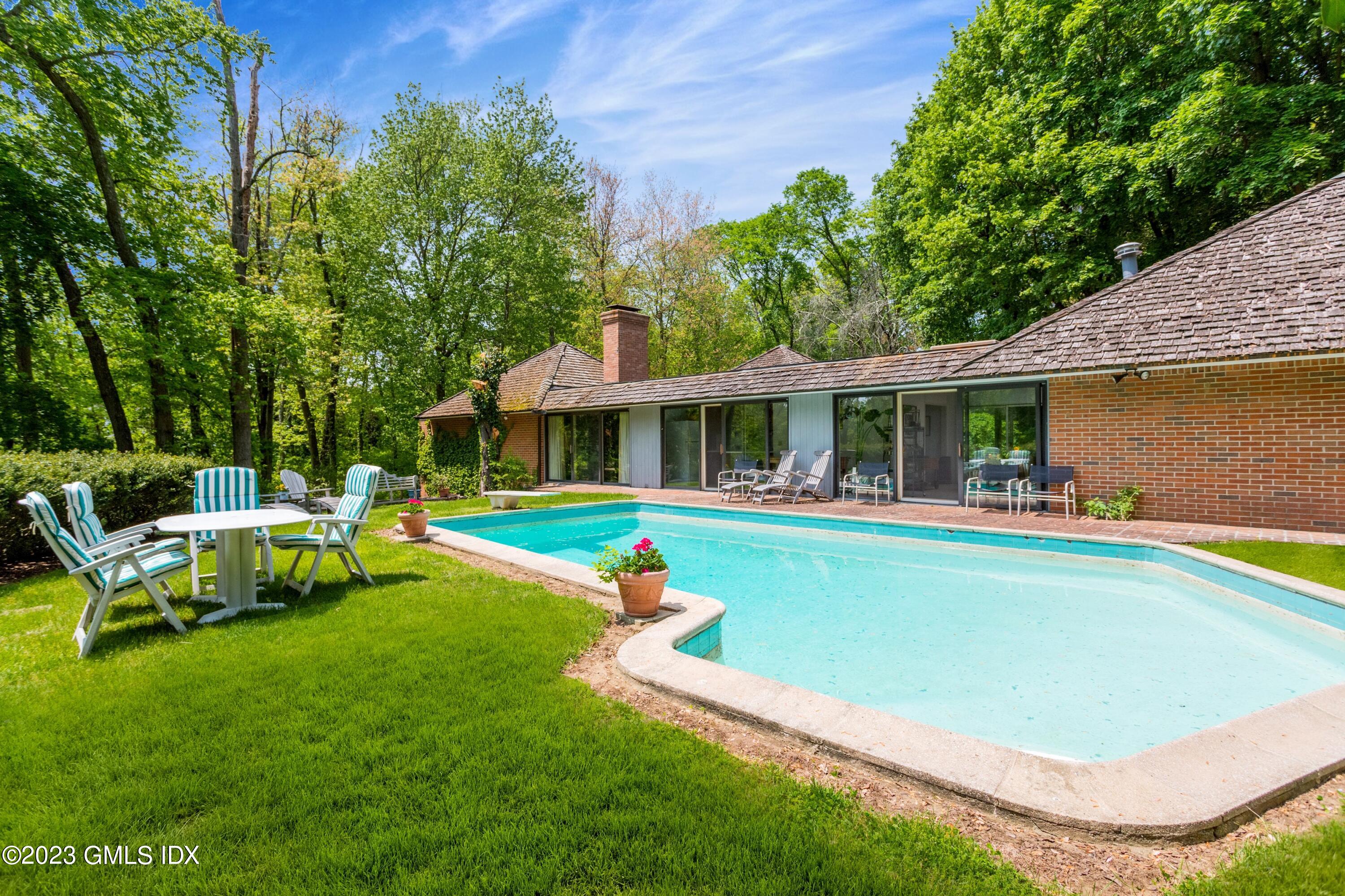 140 Round Hill Road Greenwich, CT 06831 - Photo 32 of 49 a view of an house with swimming pool and yard