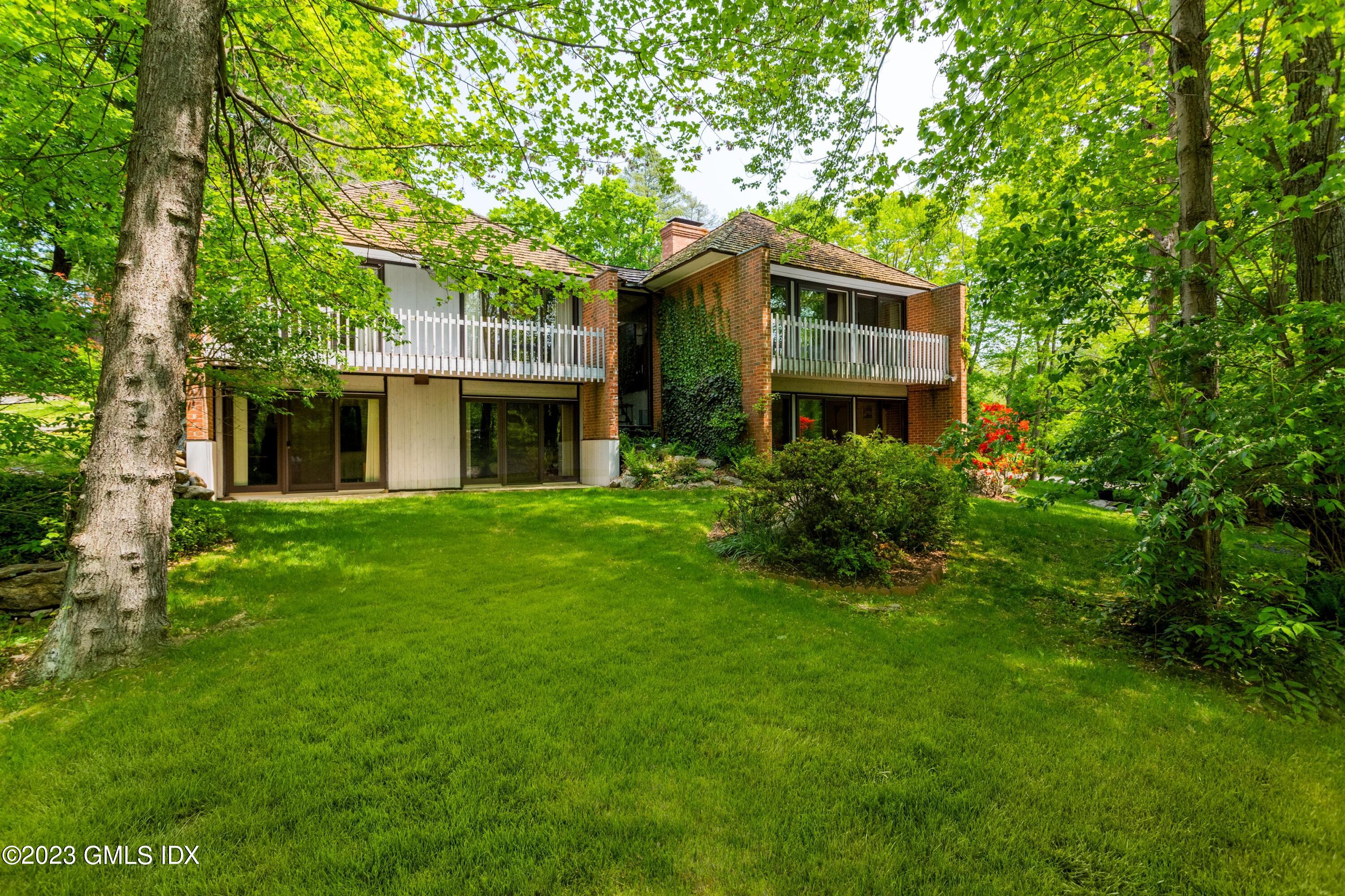 140 Round Hill Road Greenwich, CT 06831 - Photo 33 of 49 a front view of house with yard and green space