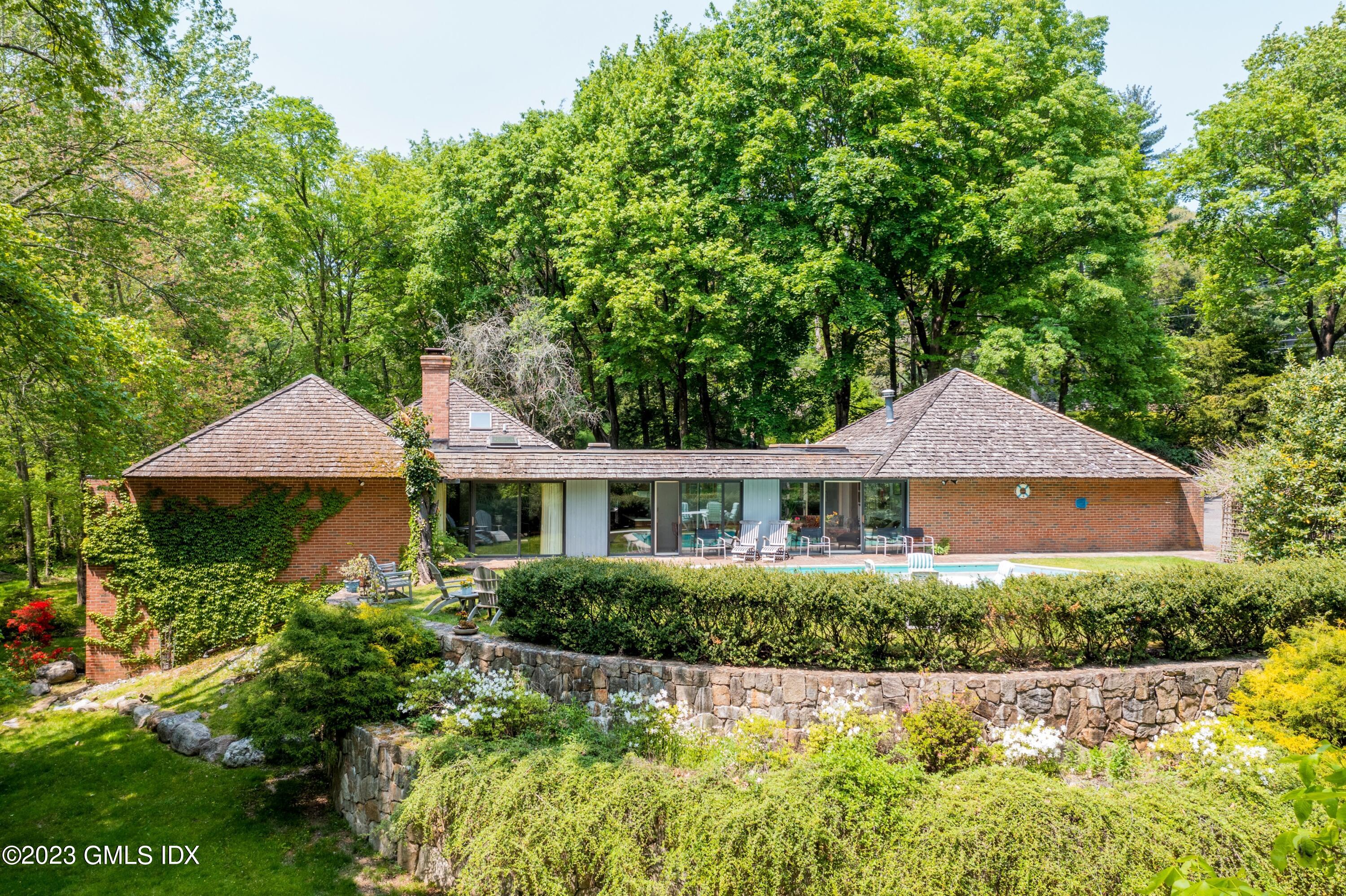 140 Round Hill Road Greenwich, CT 06831 - Photo 36 of 49 a front view of a house with a yard and porch