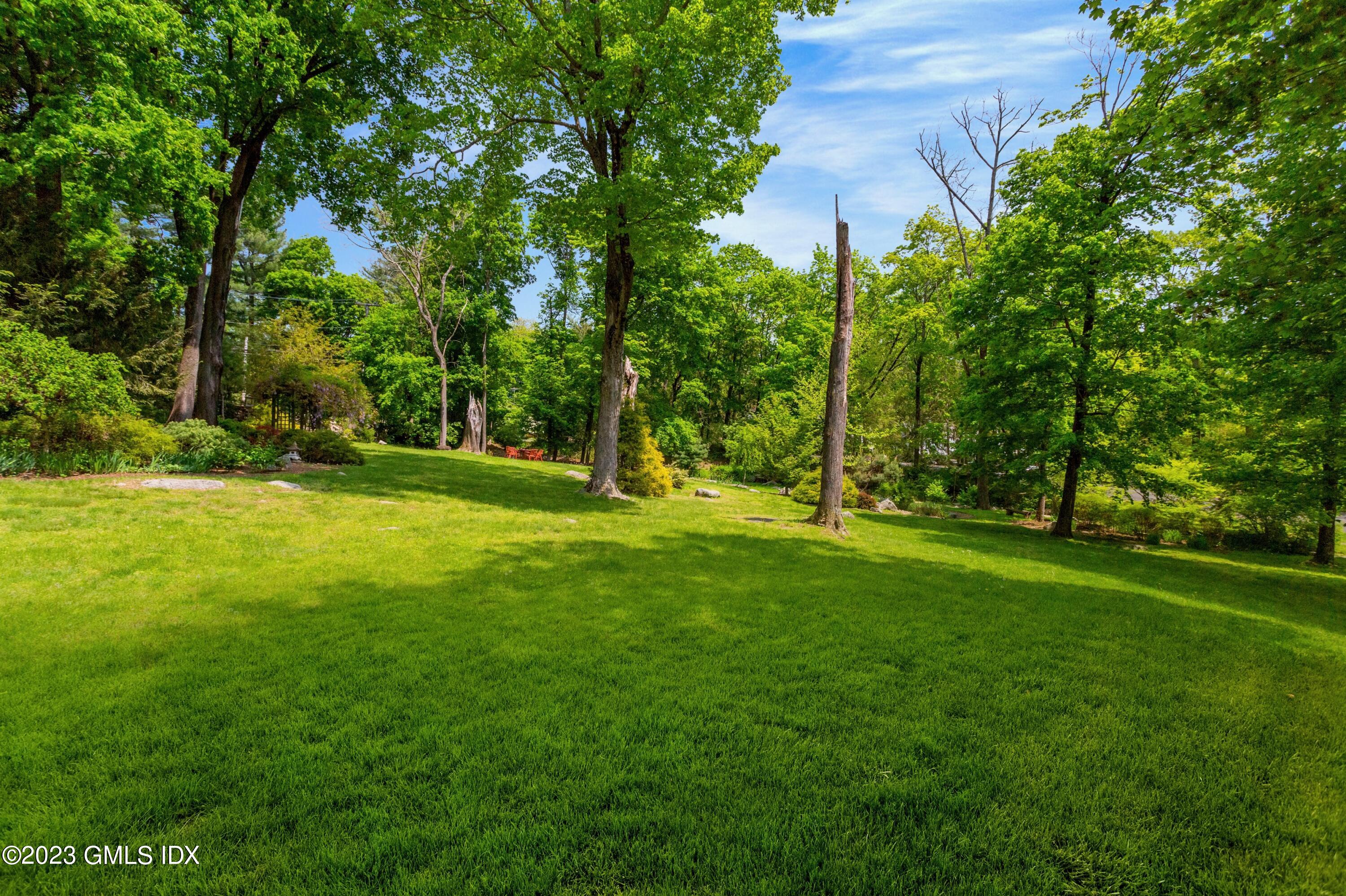 140 Round Hill Road Greenwich, CT 06831 - Photo 42 of 49 a view of a park with a tree in the grass