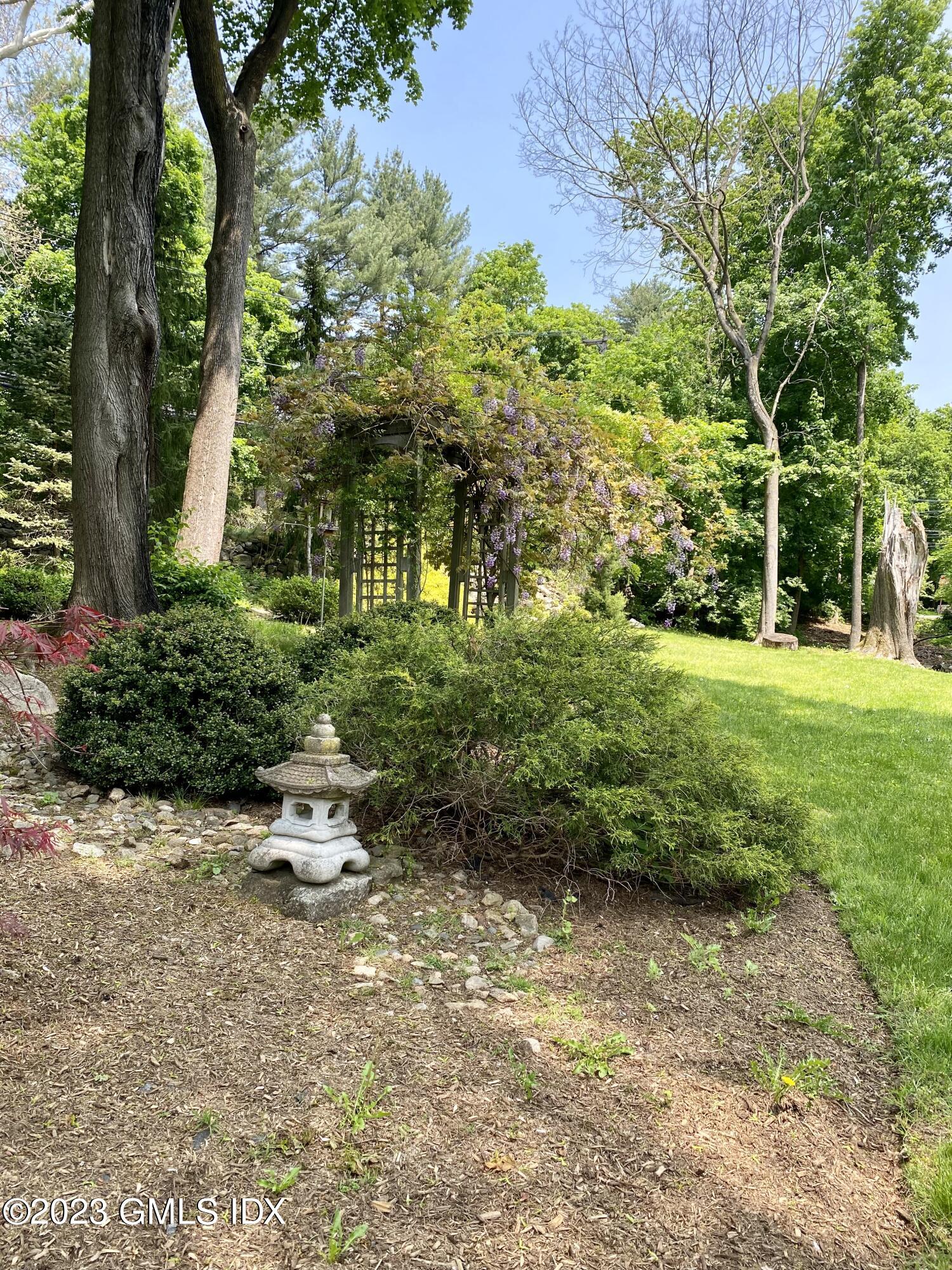 140 Round Hill Road Greenwich, CT 06831 - Photo 45 of 49 a view of backyard with outdoor seating and green space