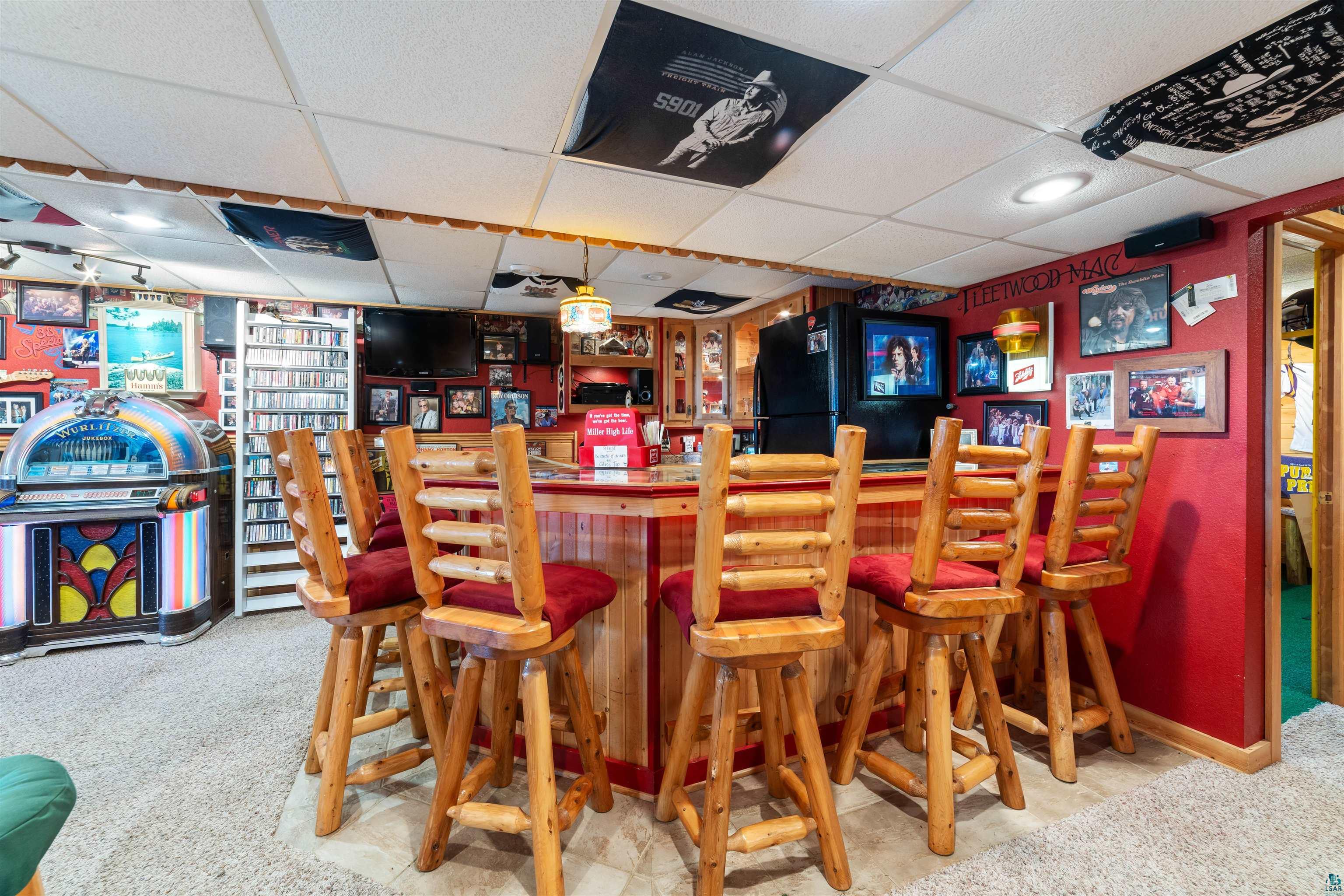 11911 East Rowe Road Lake Nebagamon, WI 54849 - Photo 54 of 61 Entertainment area featuring a built-in bar with wood-finish paneling and a red countertop